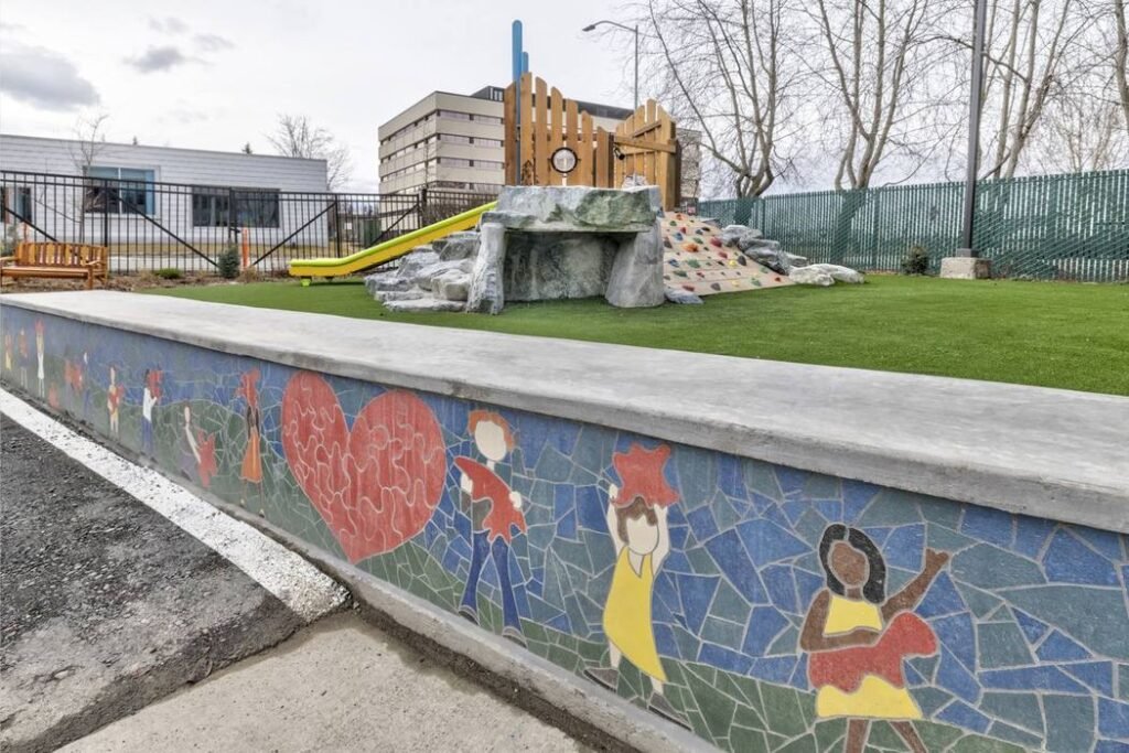 Inclusive playground with children's mural and accessible play equipment at Friendship Circle Alaska