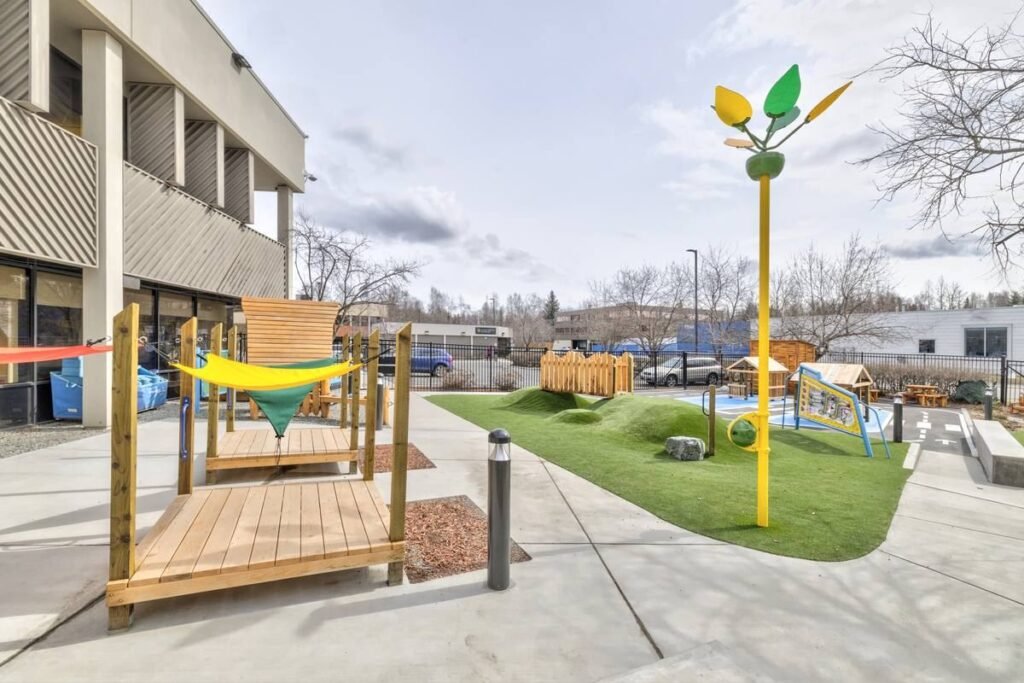 Outdoor inclusive play space with accessible pathways and play features