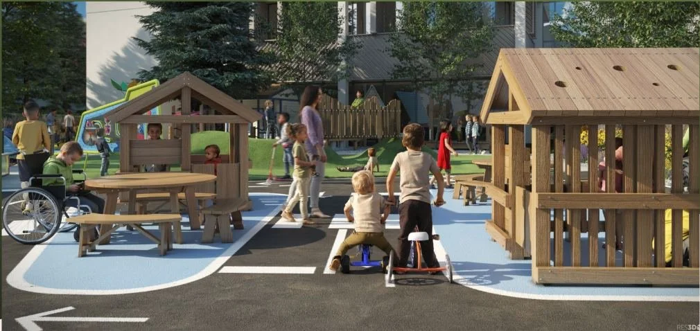 Children using trikes and exploring an accessible city track play area designed for mobility and social interaction